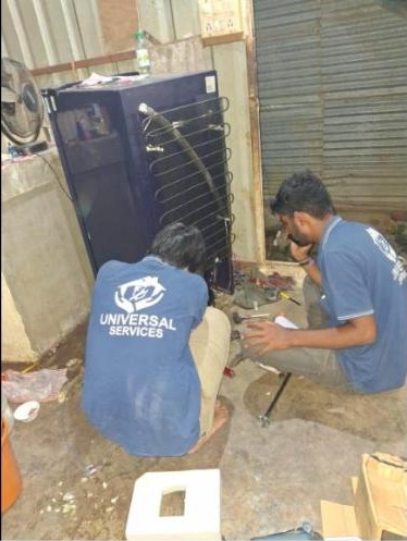 Universal Services technicians repairing a refrigerator compressor on-site