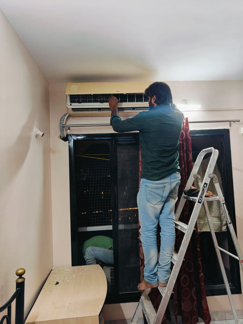 Universal Services technician installing a split AC in an apartment